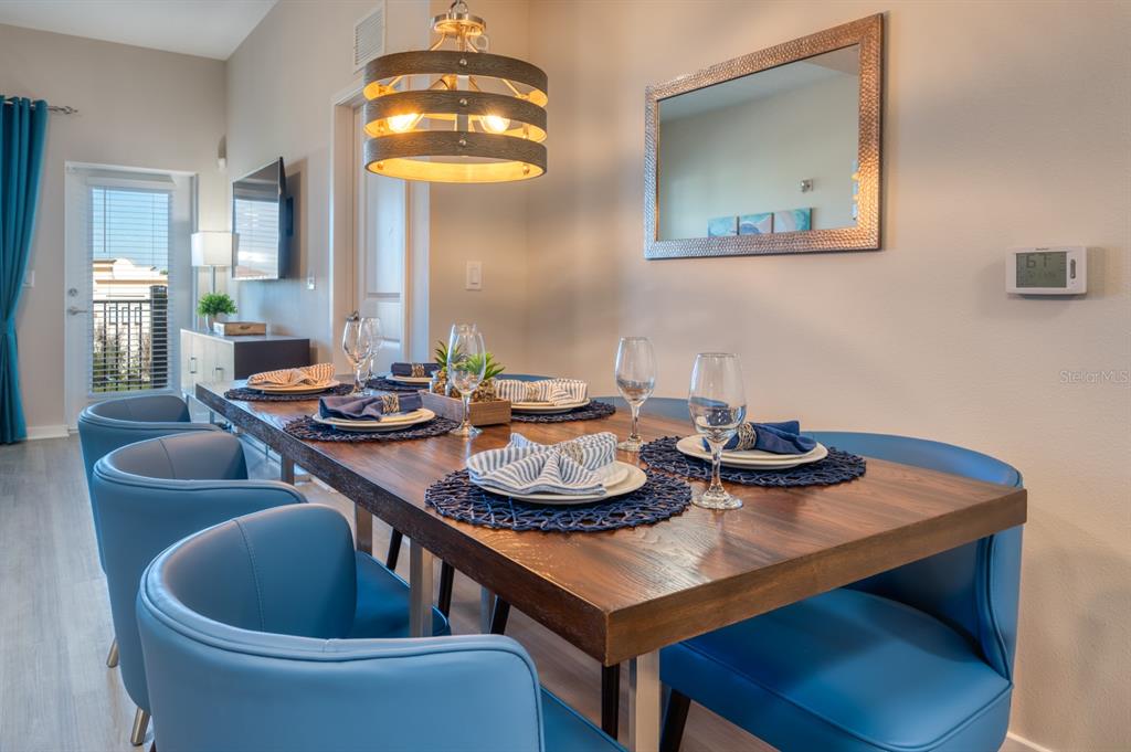 4013 Breakview Drive, Unit A407 Orlando, FL 32819 - Photo 11 of 32 a view of a dining room with furniture and wooden floor