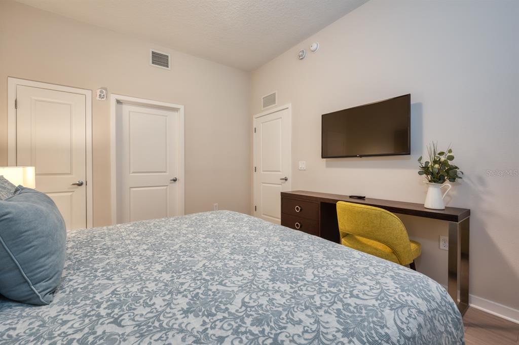 4013 Breakview Drive, Unit A407 Orlando, FL 32819 - Photo 16 of 32 a bedroom with a bed and a flat screen tv