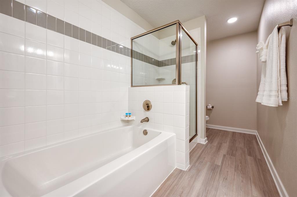 4013 Breakview Drive, Unit A407 Orlando, FL 32819 - Photo 18 of 32 a bathroom with a bathtub and a shower