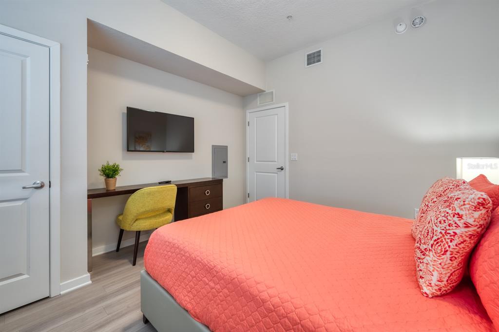 4013 Breakview Drive, Unit A407 Orlando, FL 32819 - Photo 20 of 32 a bedroom with a bed and a flat screen tv