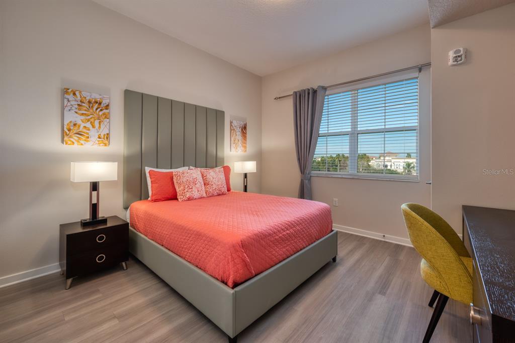 4013 Breakview Drive, Unit A407 Orlando, FL 32819 - Photo 21 of 32 a bed room with a bed and a chair