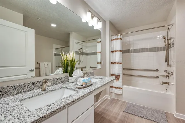 a bedroom with two bed and a flat screen tv