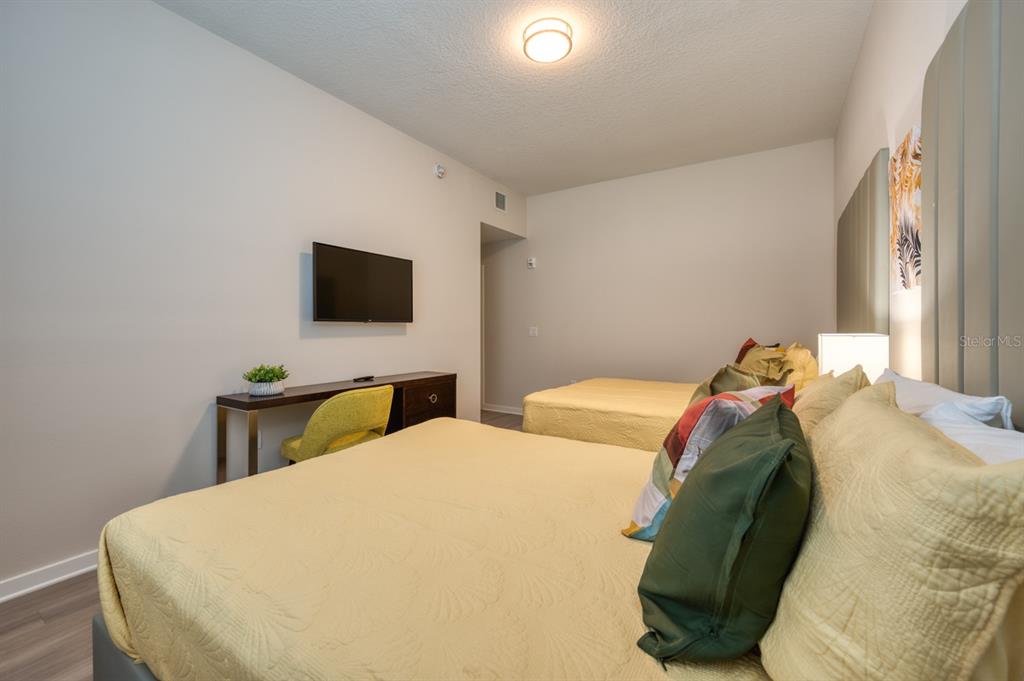 4013 Breakview Drive, Unit A407 Orlando, FL 32819 - Photo 24 of 32 a bedroom with two bed and a flat screen tv