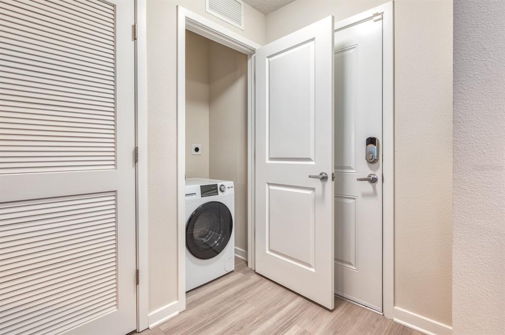 4013 Breakview Drive, Unit A407 Orlando, FL 32819 - Photo 26 of 32 a view of a hallway with washer and dryer