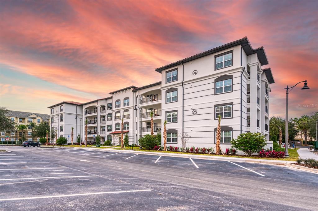 4013 Breakview Drive, Unit A407 Orlando, FL 32819 - Photo 3 of 32 a front view of a building with a yard
