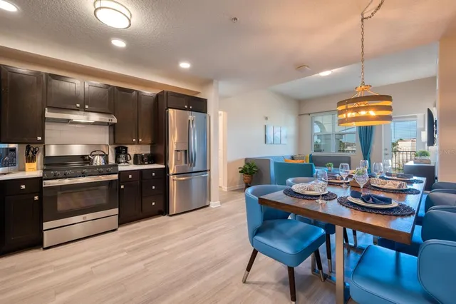 a kitchen with stainless steel appliances a refrigerator sink and cabinets