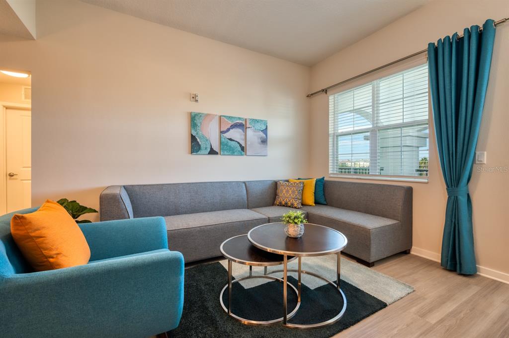 4013 Breakview Drive, Unit A407 Orlando, FL 32819 - Photo 9 of 32 a living room with furniture and a window