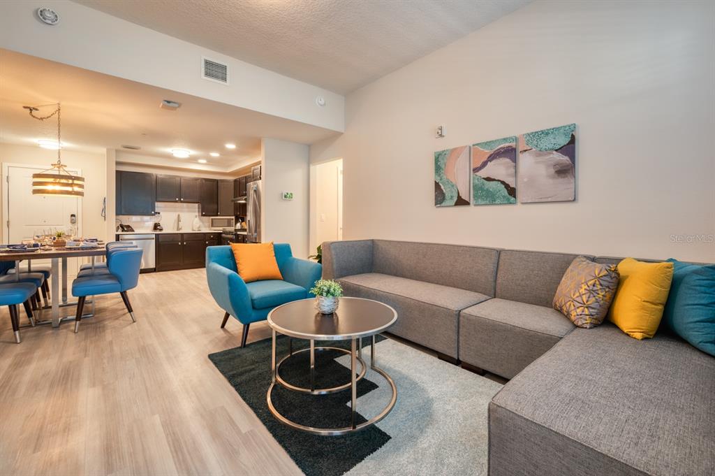 4013 Breakview Drive, Unit A407 Orlando, FL 32819 - Photo 10 of 32 a living room with furniture and kitchen view