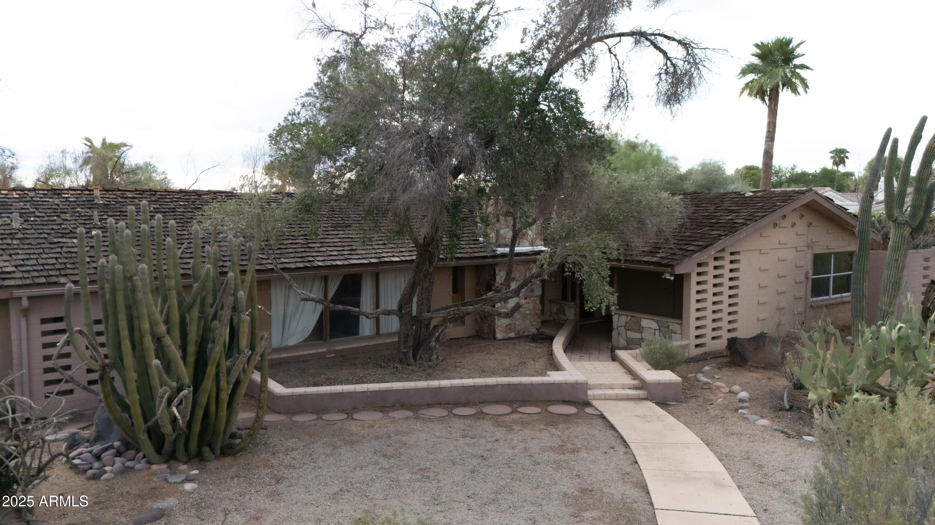 6701 East Mockingbird Lane Paradise Valley, AZ 85253 - Photo 5 of 5 a front view of a house with a yard and garage