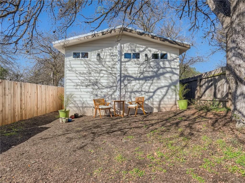 1614 Elmira Road Austin, TX 78721 - Photo 13 of 23 A private backyard oasis features a charming detached structure, perfect for a studio or office.