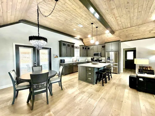 a large kitchen with a table and chairs in it