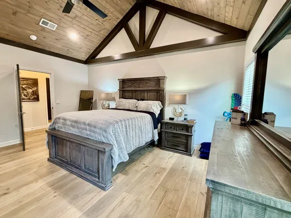a kitchen with stainless steel appliances kitchen island granite countertop a table chairs sink and cabinets