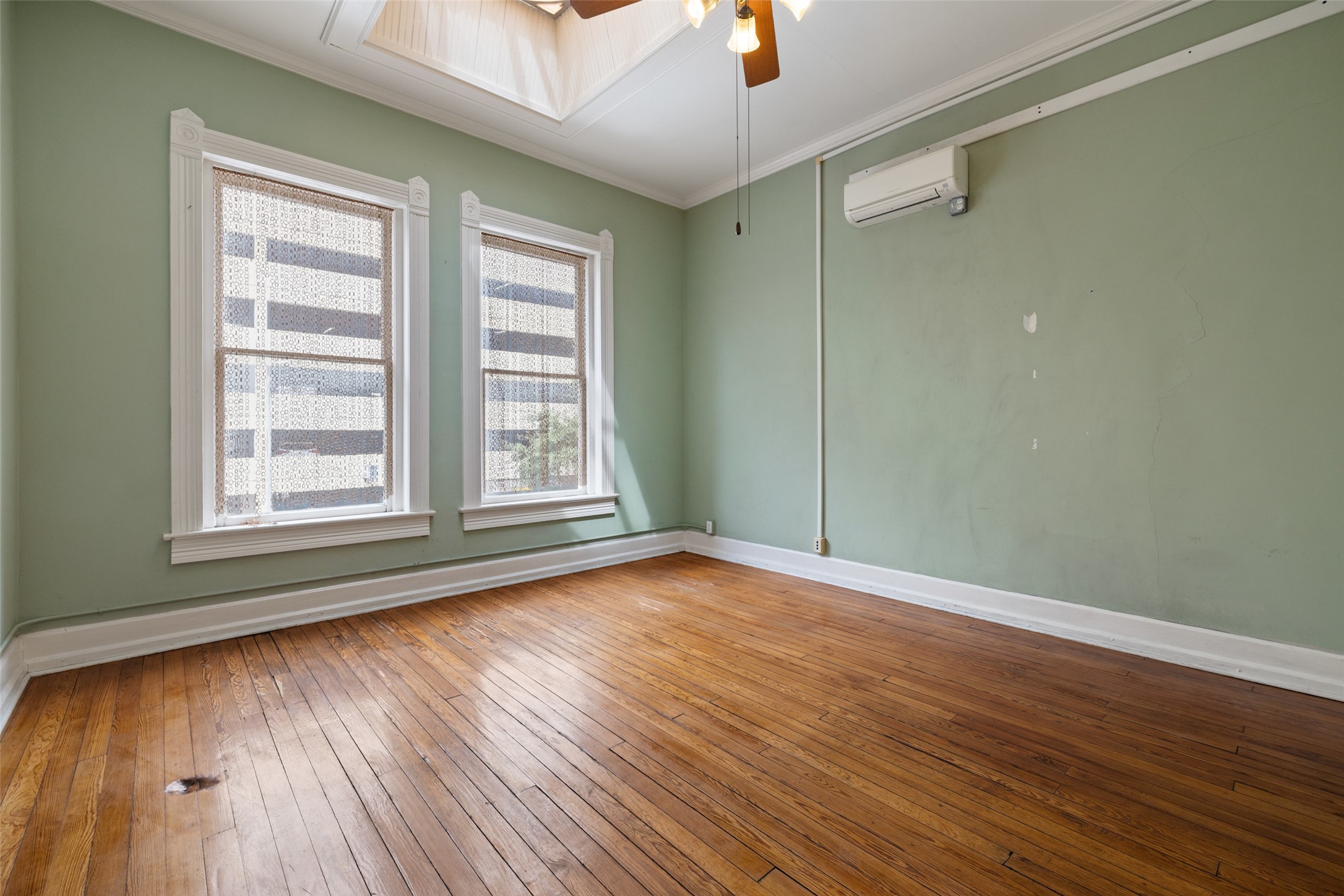 109 East 10th Street Austin, TX 78701 - Photo 15 of 38 Empty room featuring light wood finished floors, a ceiling fan, and ornamental molding