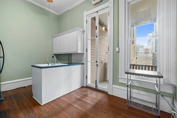 a room with a wooden floor and a window
