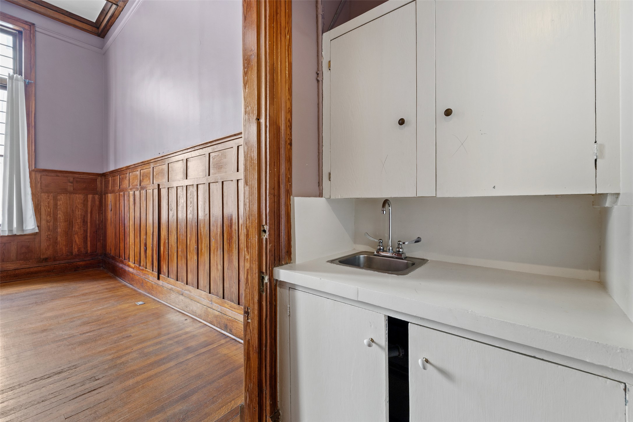109 East 10th Street Austin, TX 78701 - Photo 26 of 38 Laundry area with wooden walls, a wainscoted wall, hardwood / wood-style floors, and crown molding