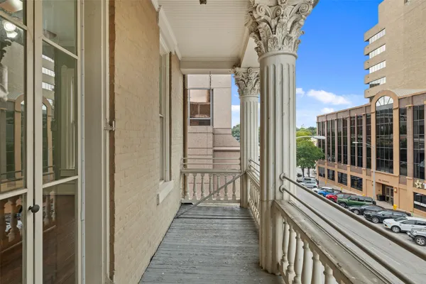 a view of a balcony with wooden floor