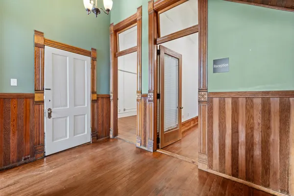 an entryway with wooden floor and door