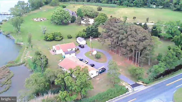 an aerial view of a house a yard and a lake view