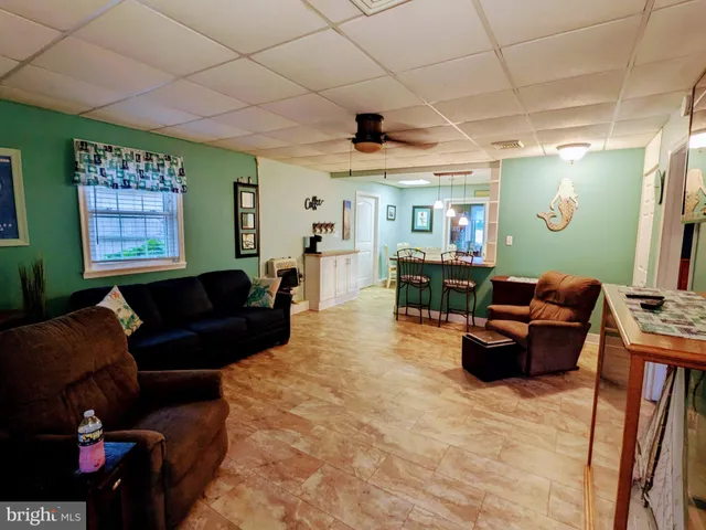 a living room with furniture a dining table and a fireplace
