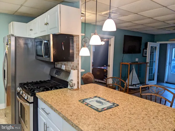 a living room with furniture a flat screen tv and gym equipment