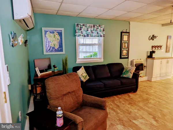 a kitchen with stainless steel appliances granite countertop a sink dishwasher a stove a refrigerator a dining table and chairs with wooden floor