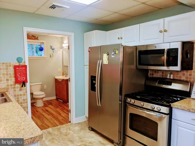 a bedroom with a bed and a large window with a flat tv screen