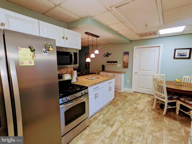 a bedroom with bed and wooden floor