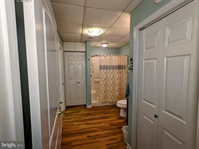 a aerial view of a house next to a big yard with plants and large trees