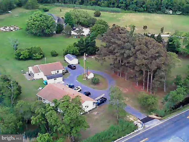 an aerial view of a house with a yard and lake view