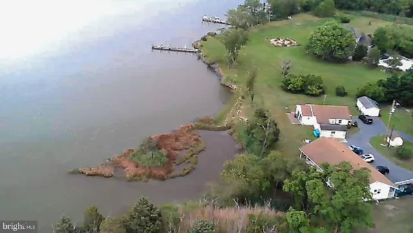 an aerial view of a house with a yard and lake view