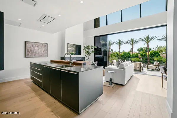a kitchen with stainless steel appliances kitchen island granite countertop a stove and a view of living room