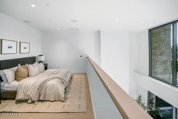 a bedroom with a bed and a large window