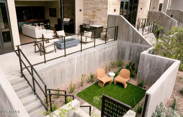 a view of a balcony with chairs and a potted plant