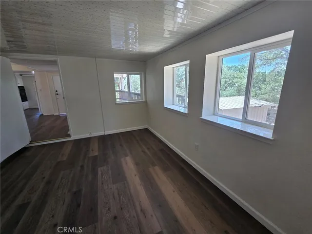 a view of a room with wooden floor and windows