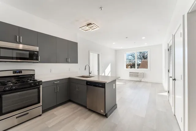 a kitchen with stainless steel appliances granite countertop a stove and a sink