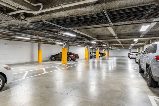a view of parking garage with cars