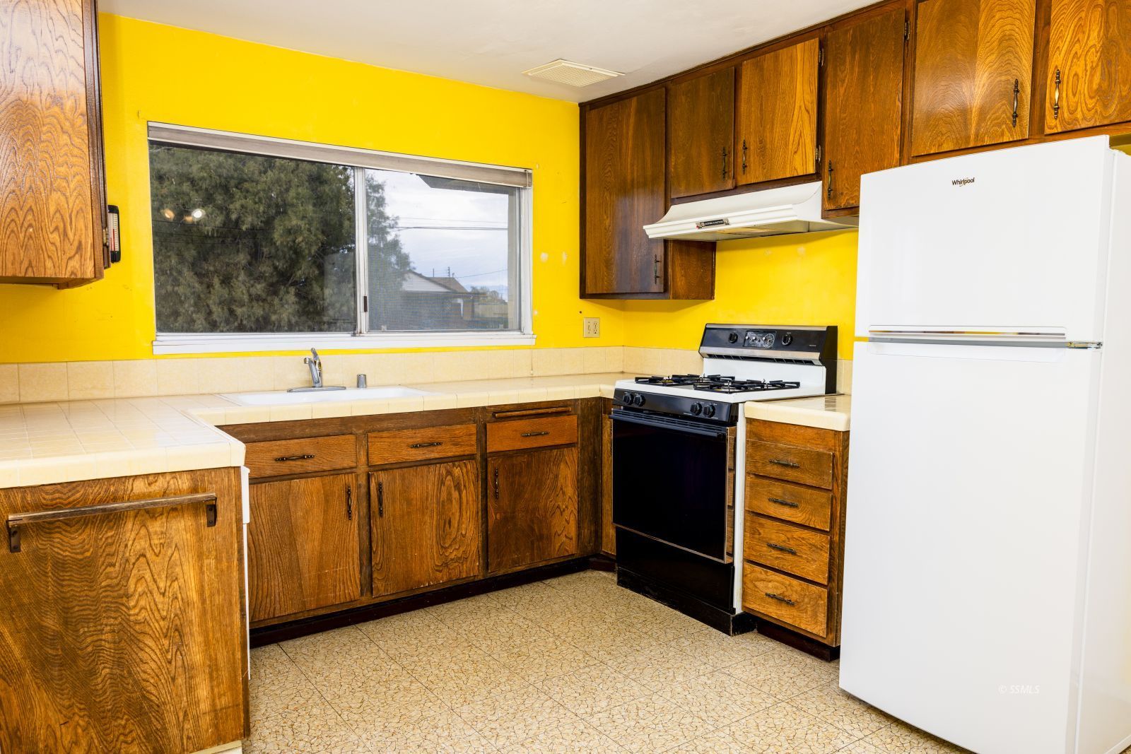 723 West Church Avenue Ridgecrest, CA 93555 - Photo 10 of 24 a kitchen with stainless steel appliances a stove a sink and a refrigerator with wooden floor