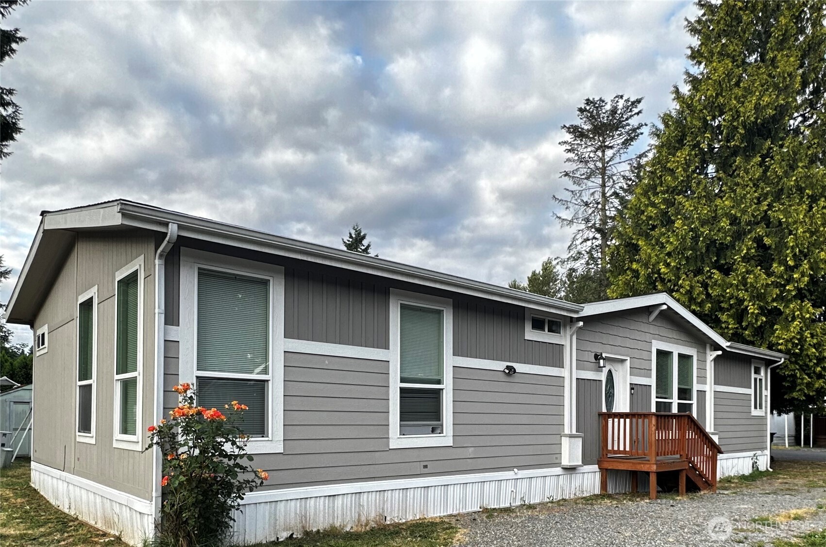 a front view of a house with a garden
