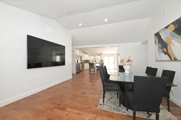 a dining room with furniture and wooden floor
