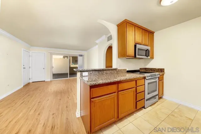 a spacious bathroom with a granite countertop sink and a mirror