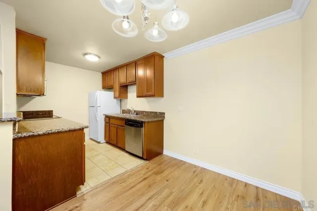 a kitchen with stainless steel appliances granite countertop a sink and a stove top oven