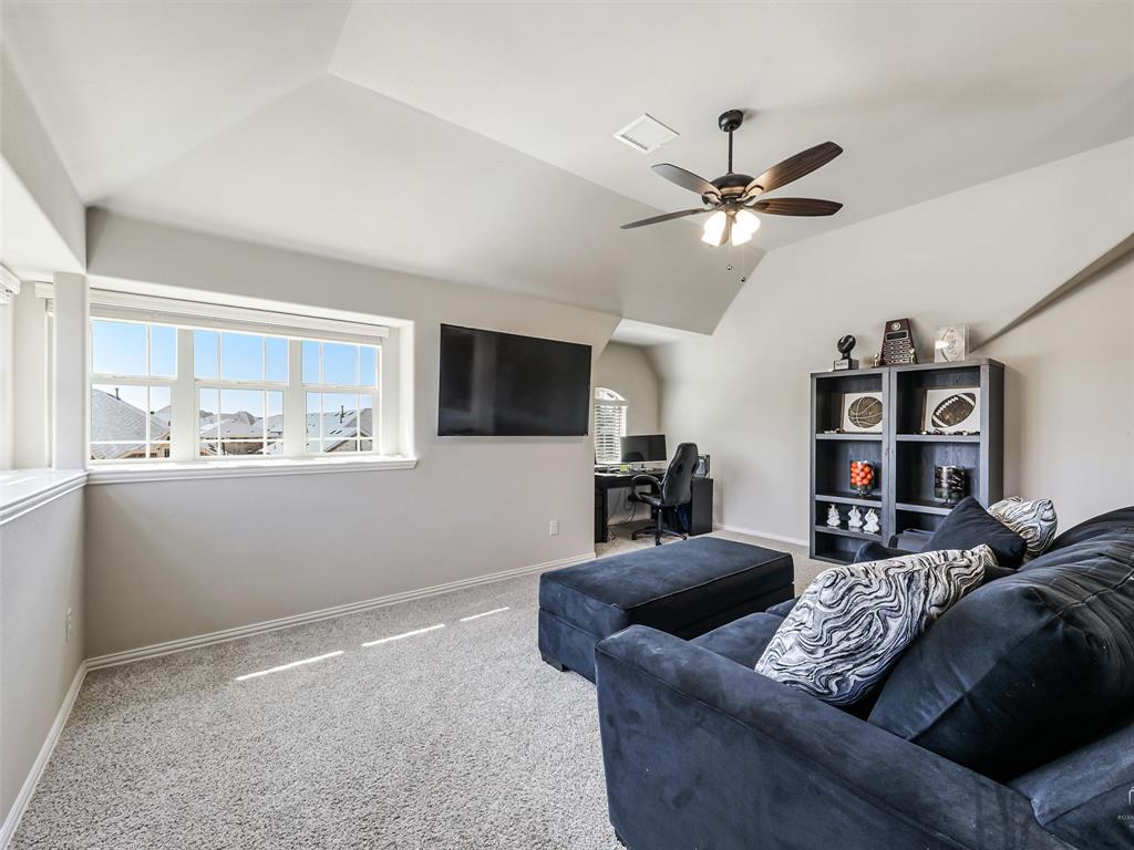 1216 Tree Shadow Lane Anna, TX 75409 - Photo 27 of 37 a living room with furniture and a flat screen tv