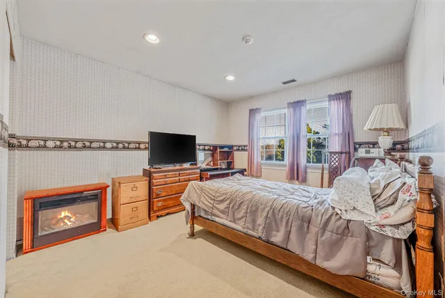 a bedroom with a large bed and a television