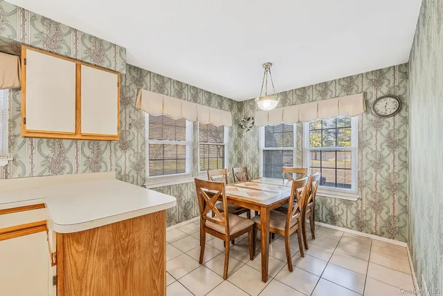 a dining room with furniture and window