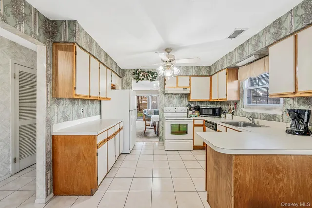 a kitchen with a sink a counter top space stainless steel appliances and cabinets