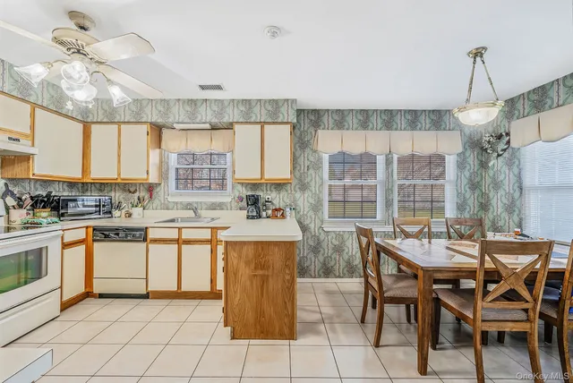 a kitchen with a stove a table and chairs in it