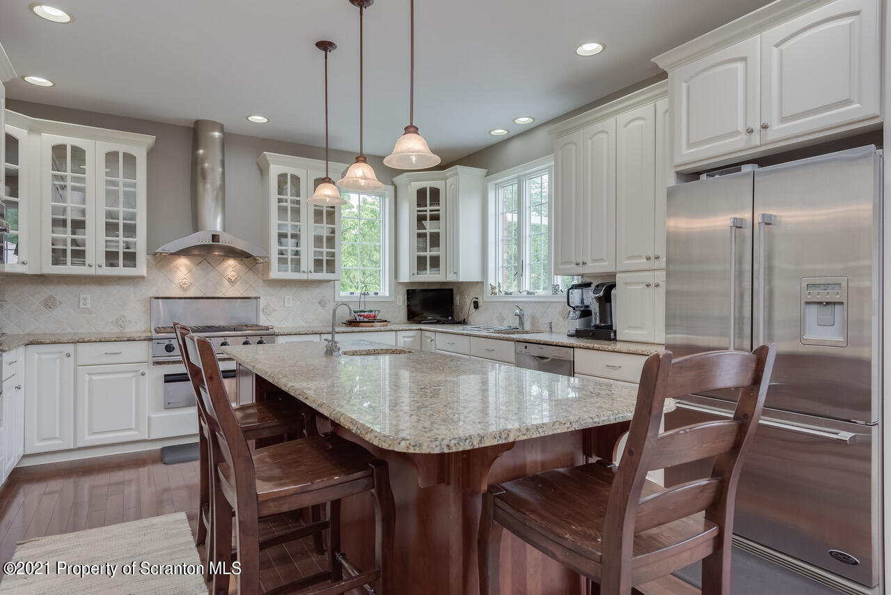 14 Kipling Drive Moosic, PA 18507 - Photo 11 of 42 a kitchen with granite countertop a table chairs sink and cabinets