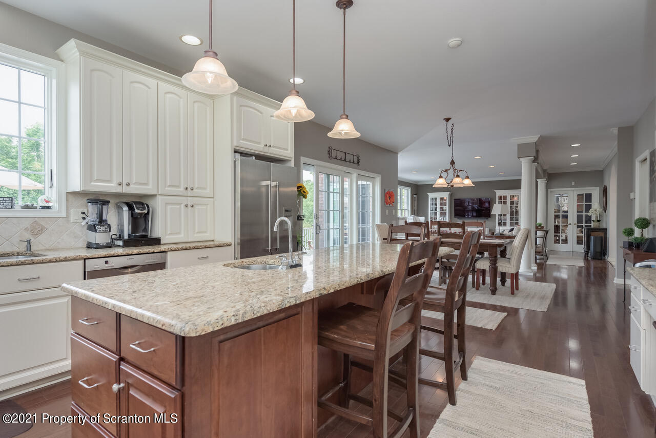 14 Kipling Drive Moosic, PA 18507 - Photo 13 of 42 a kitchen with stainless steel appliances kitchen island granite countertop a table chairs sink and cabinets