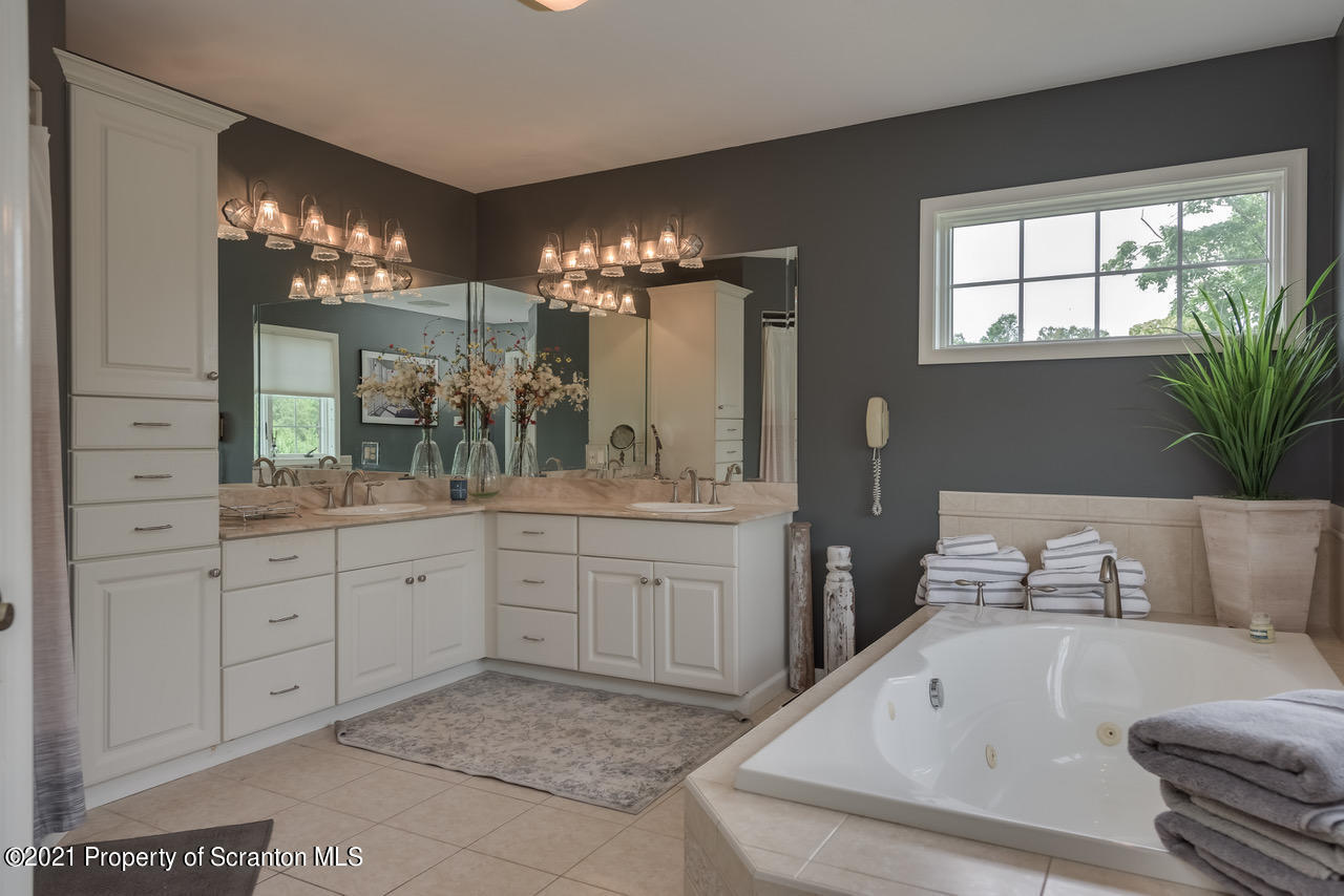 14 Kipling Drive Moosic, PA 18507 - Photo 19 of 42 a bathroom with a tub sink and mirror