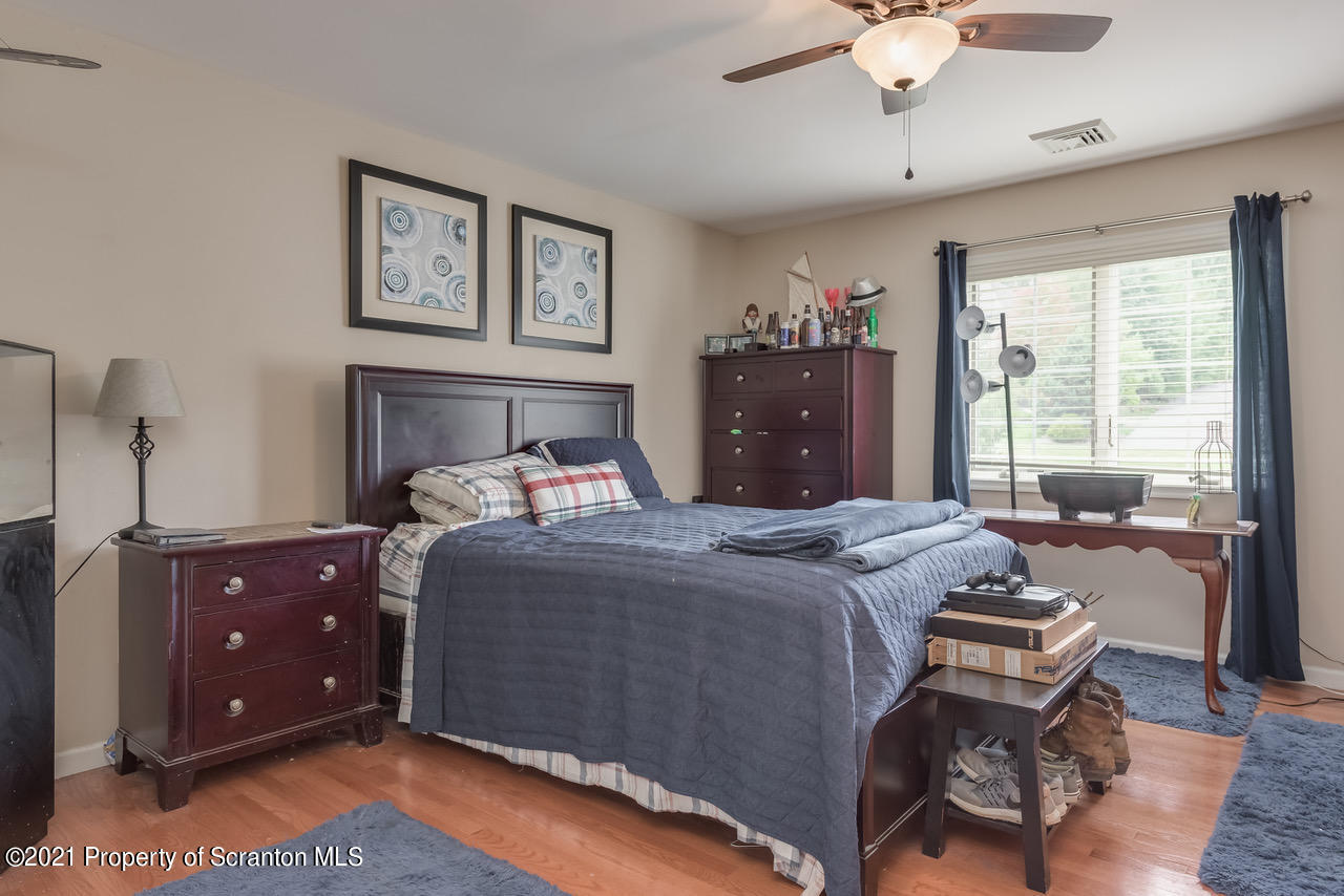 14 Kipling Drive Moosic, PA 18507 - Photo 21 of 42 a bedroom with a bed and wooden floor